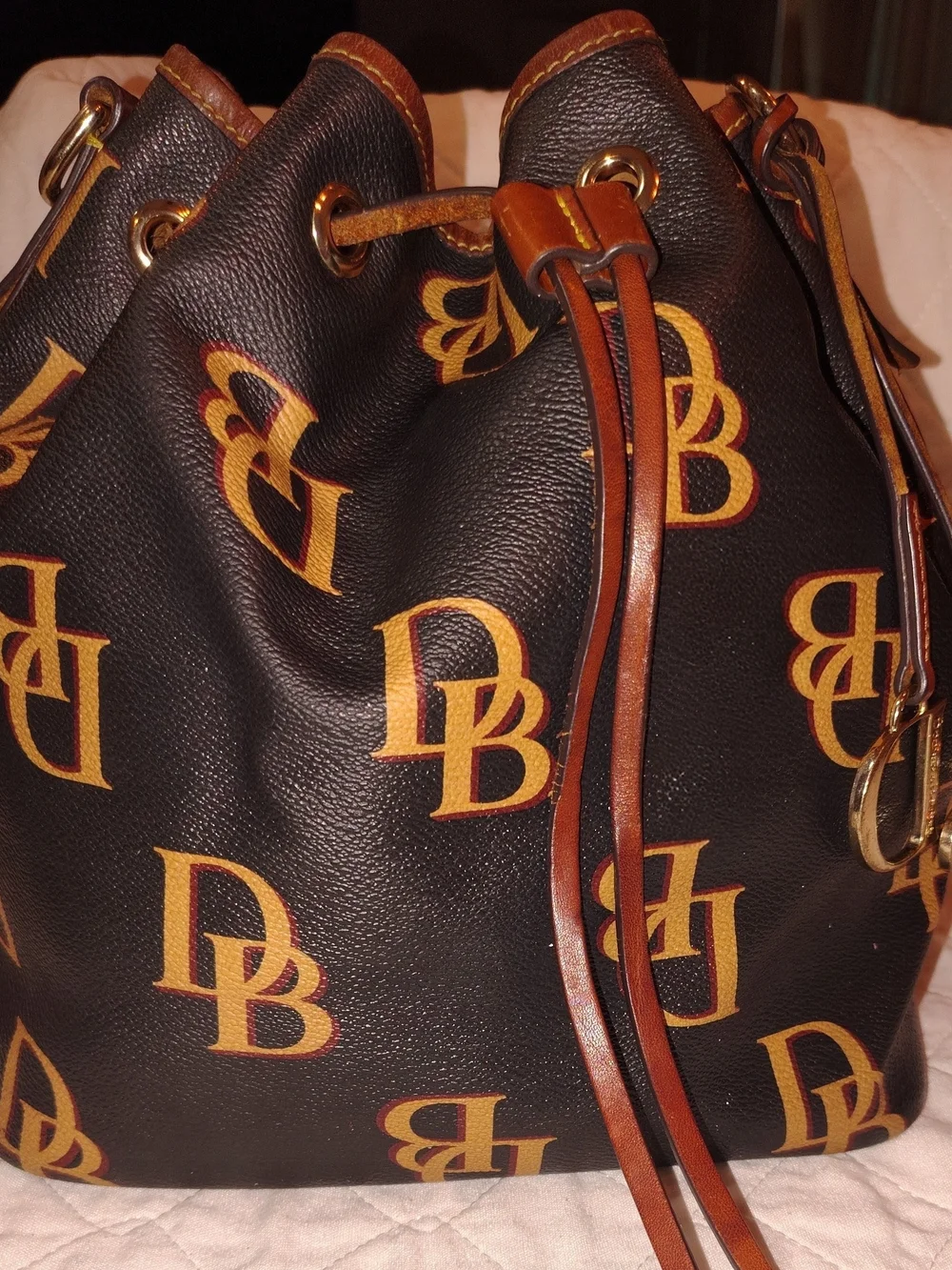 Dooney & Bourke Black and Tan Monogram Drawstring Bucket Bag